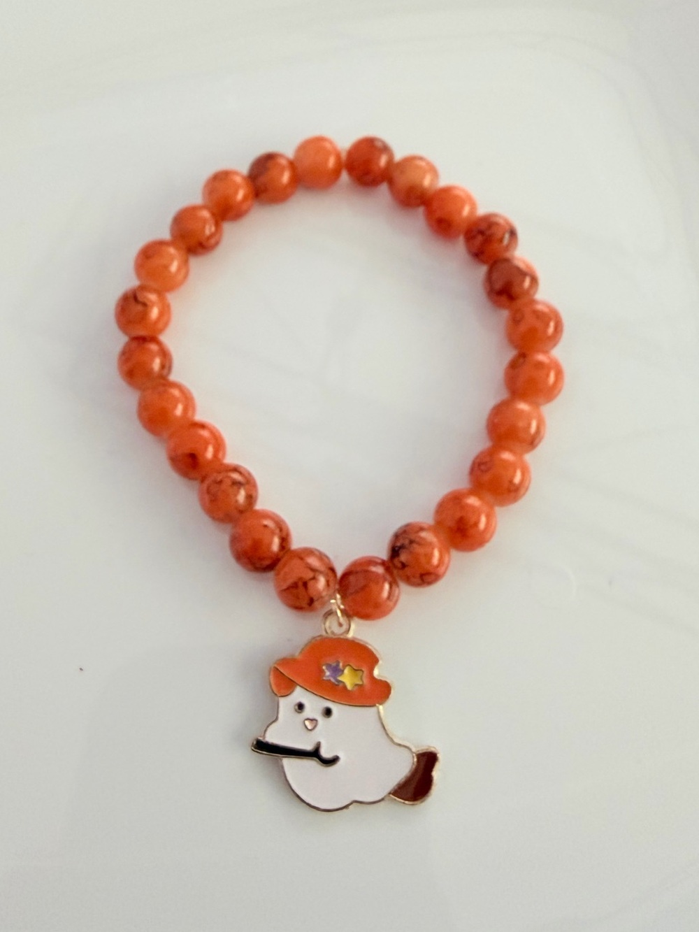 Orange Beaded Bracelet with Playful Ghost Charm